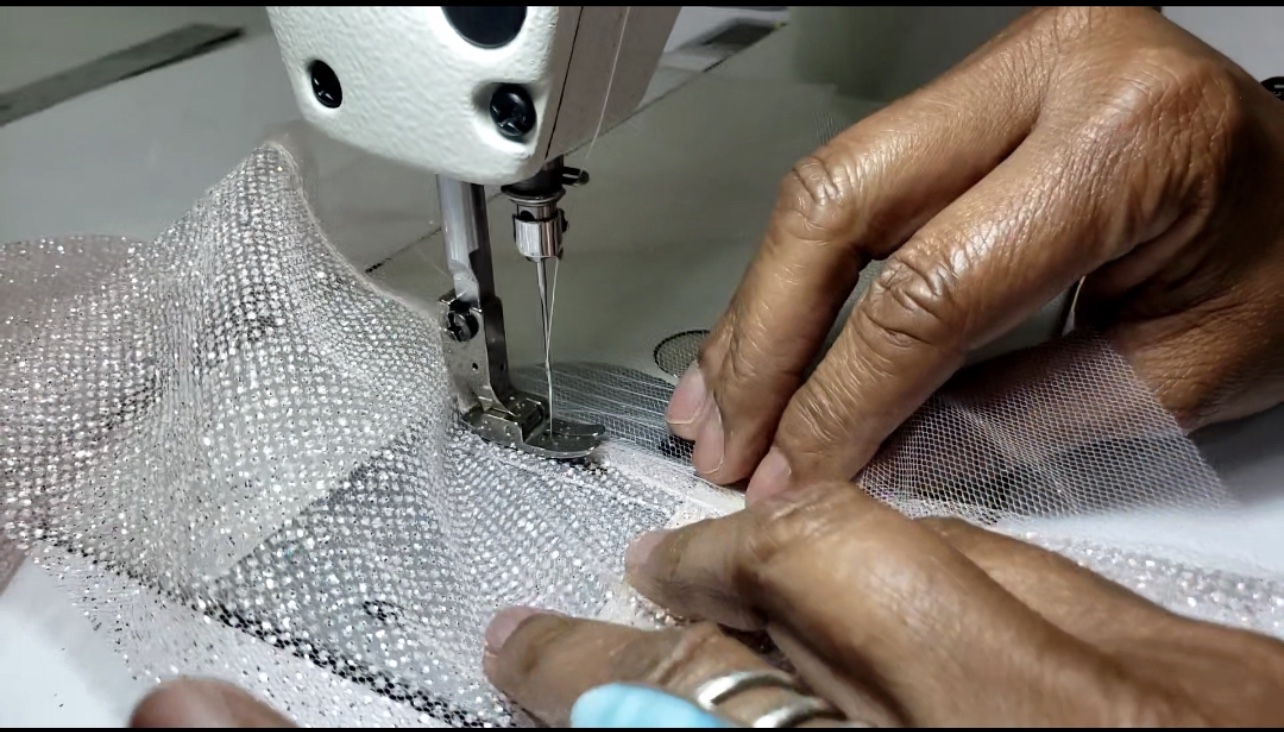 Margo West Bridal Couture artisan hands at industrial sewing machine Dallas TX