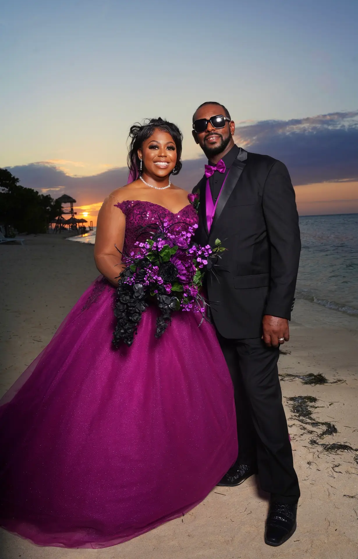 Bride and groom on a beach at sunset wearing a custom Margo West gown, Dallas TX