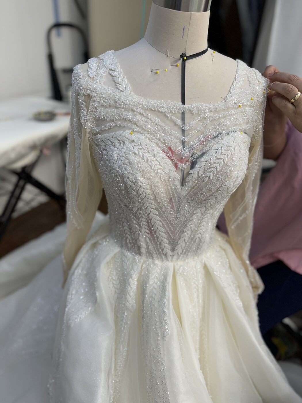 Beadwork and lace applique detail on a bridal gown at Margo West Bridal Couture Dallas TX