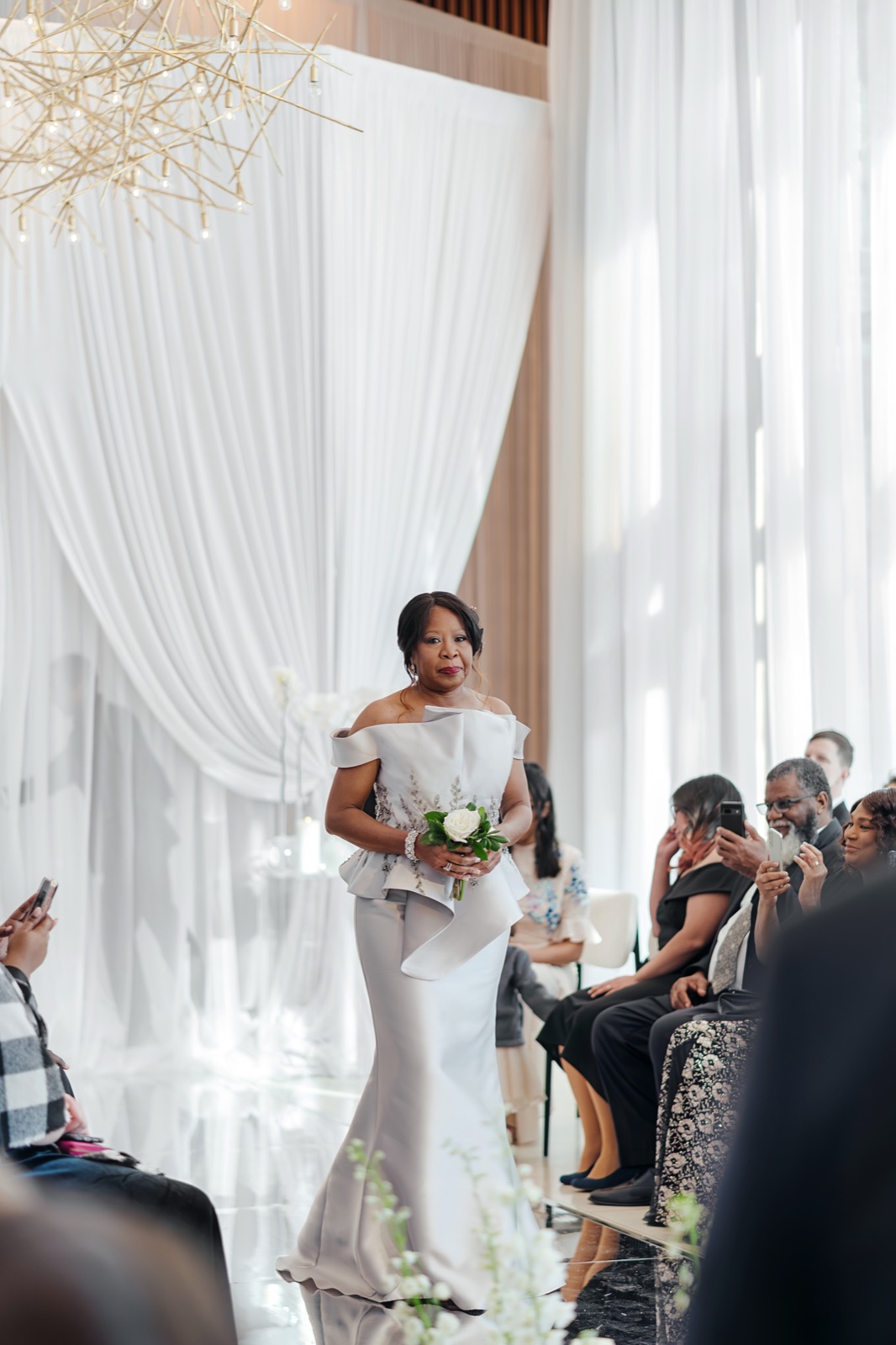 Bride walking the aisle in a fitted wedding gown by Margo West Bridal Couture, Dallas TX