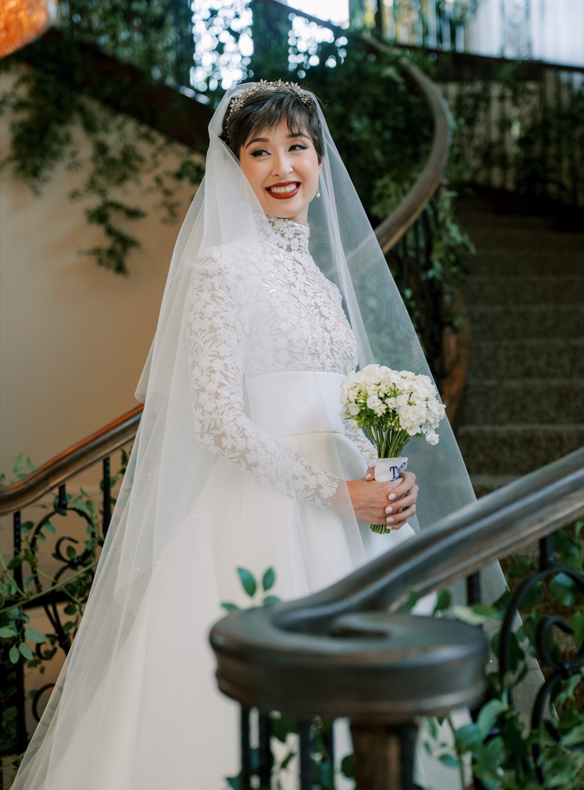 Bride in a long sleeve high-neck lace wedding gown by Margo West Bridal Couture, Dallas TX