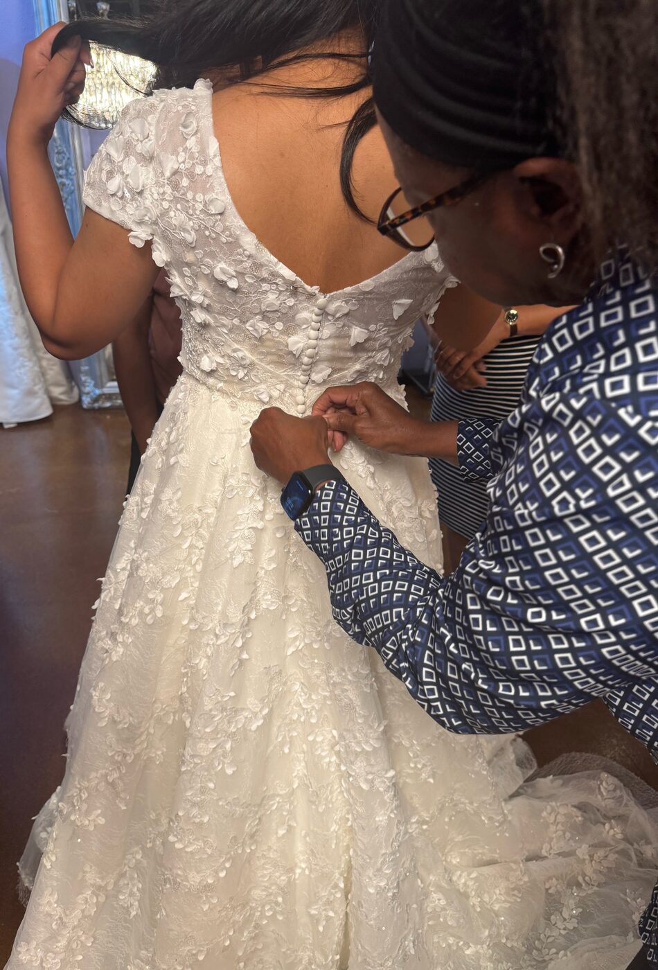 Seamstress hand-finishing a sleeve redesign at Margo West Bridal Couture Dallas TX